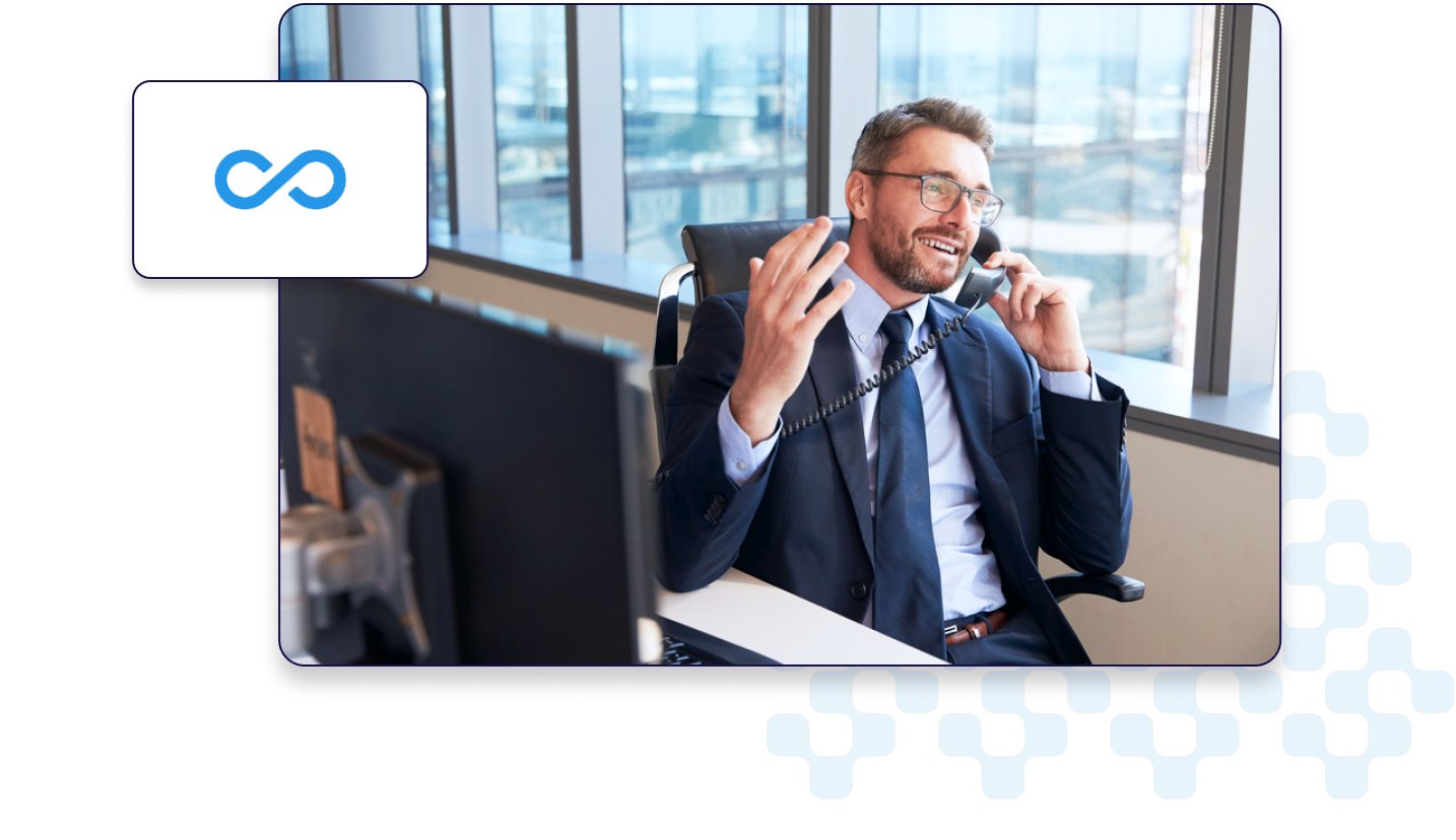 A business professional talking on the phone at a modern office desk